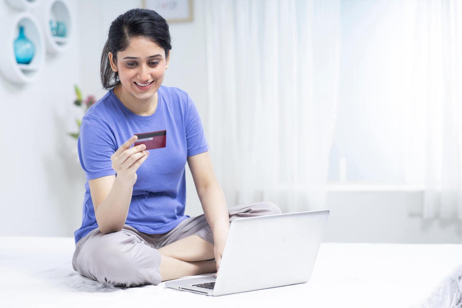 Woman making a transaction with card on her laptop