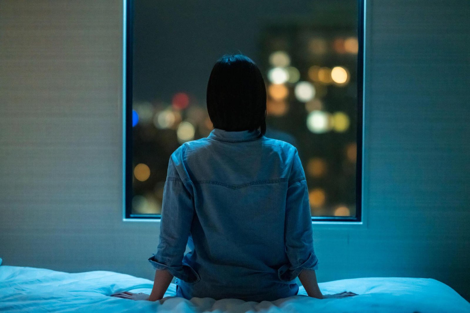 Woman sitting on bed